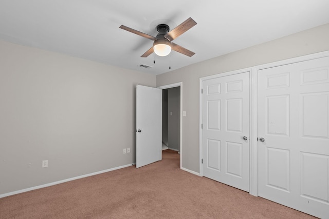 unfurnished bedroom featuring light colored carpet and ceiling fan