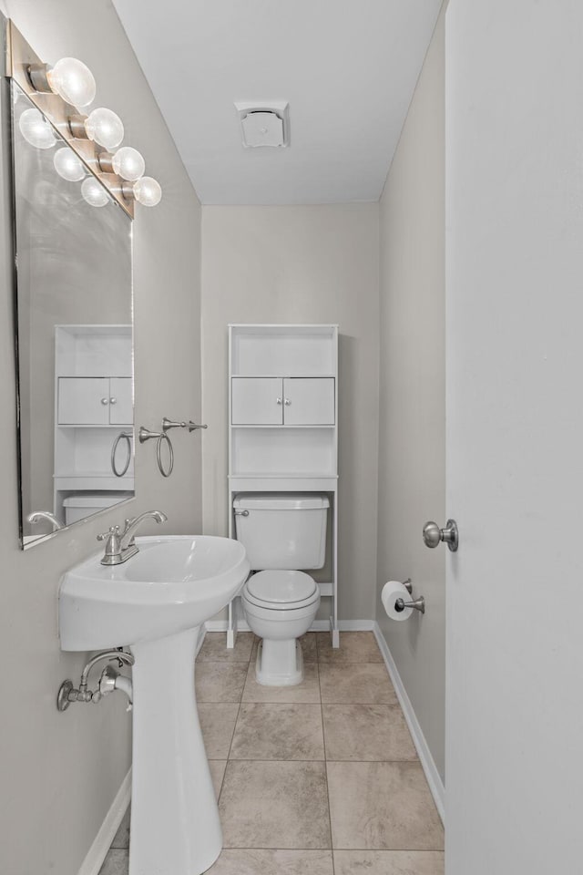 bathroom with tile patterned floors and toilet