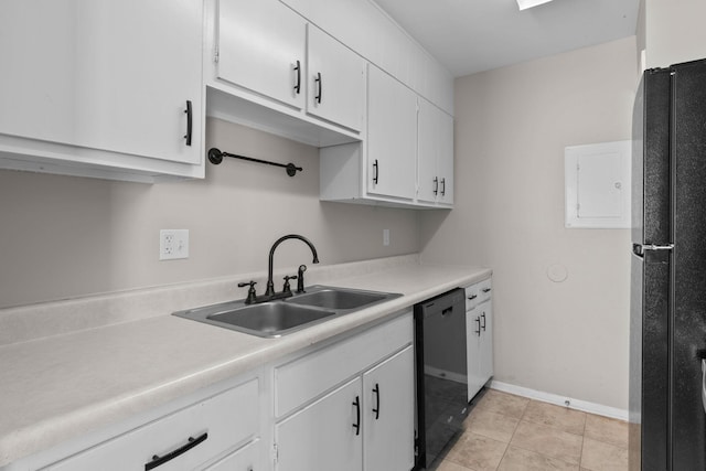 kitchen with sink, black appliances, white cabinets, and light tile patterned flooring