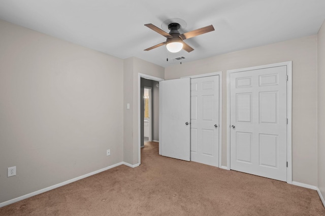 unfurnished bedroom with light colored carpet and ceiling fan