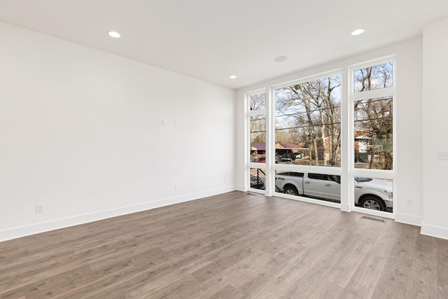 spare room with wood-type flooring