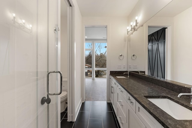 bathroom with vanity, toilet, and tile patterned flooring