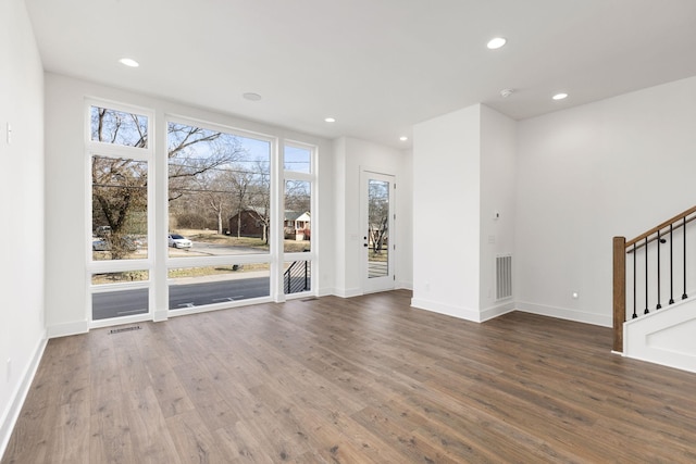 unfurnished living room with dark wood-type flooring