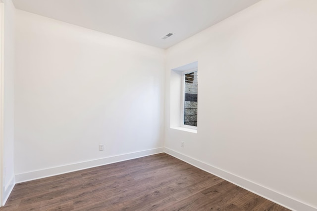 spare room featuring dark hardwood / wood-style flooring