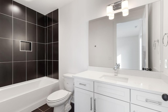 full bathroom featuring vanity, toilet, tiled shower / bath combo, and tile patterned flooring