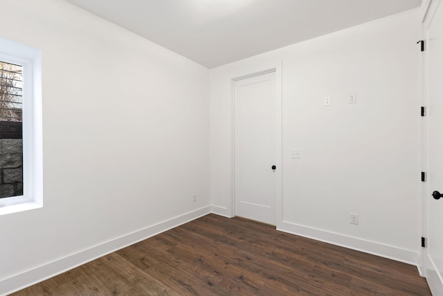 empty room with dark wood-type flooring