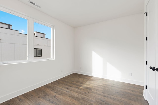 spare room with dark hardwood / wood-style floors