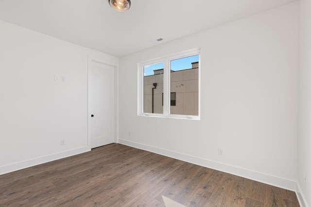 unfurnished room featuring dark hardwood / wood-style flooring