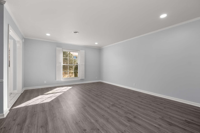 spare room with dark wood-type flooring, recessed lighting, crown molding, and baseboards