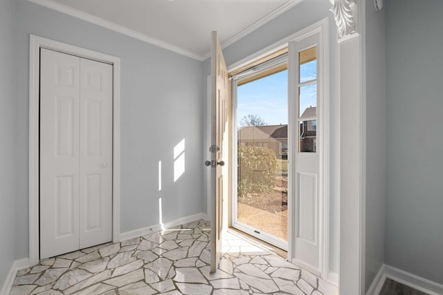 doorway with baseboards and crown molding