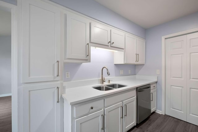 kitchen featuring dark wood-style floors, a sink, light countertops, white cabinets, and dishwasher