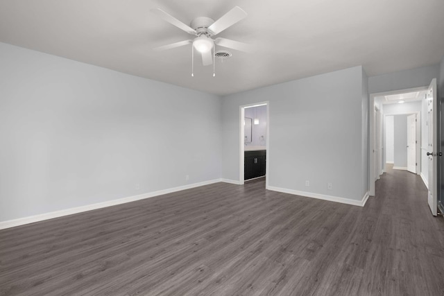 unfurnished room featuring dark wood-style floors, visible vents, a ceiling fan, and baseboards