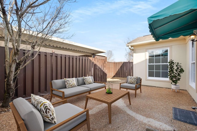 view of patio with an outdoor living space and a fenced backyard