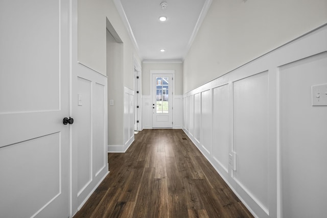 doorway featuring ornamental molding and dark hardwood / wood-style floors