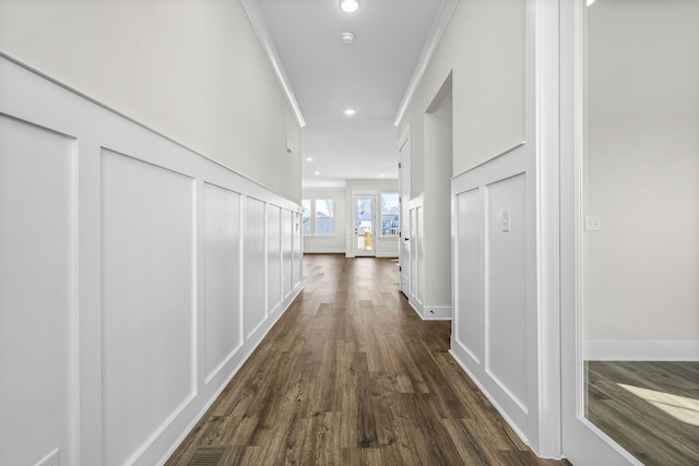 hall featuring ornamental molding and dark hardwood / wood-style floors