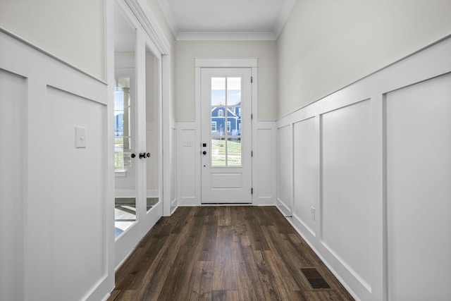 doorway to outside featuring dark wood-type flooring and ornamental molding