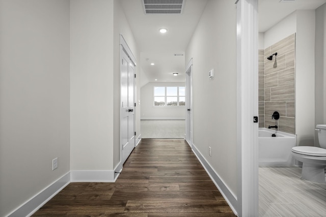 hall with hardwood / wood-style floors