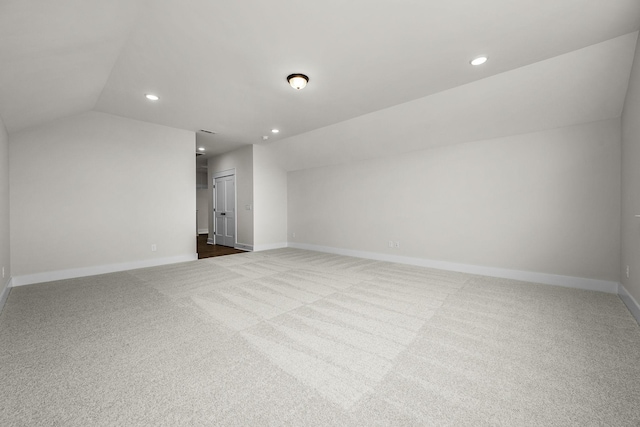 bonus room featuring vaulted ceiling and carpet