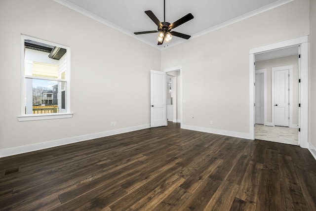 spare room featuring dark hardwood / wood-style flooring, crown molding, ceiling fan, and a high ceiling