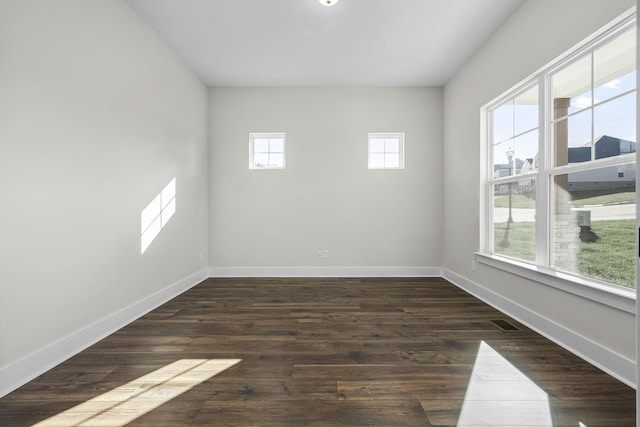 spare room featuring dark wood-type flooring