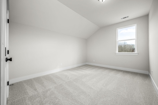 bonus room with lofted ceiling and carpet floors