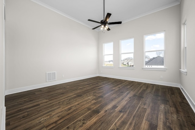 empty room featuring dark hardwood / wood-style flooring, crown molding, and ceiling fan