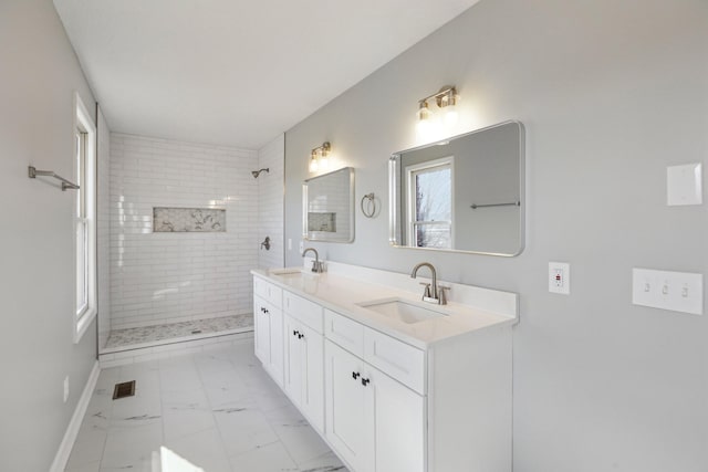 bathroom featuring vanity and tiled shower