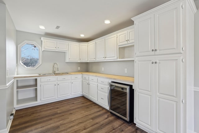 kitchen featuring wine cooler, white cabinetry, dark hardwood / wood-style flooring, and sink