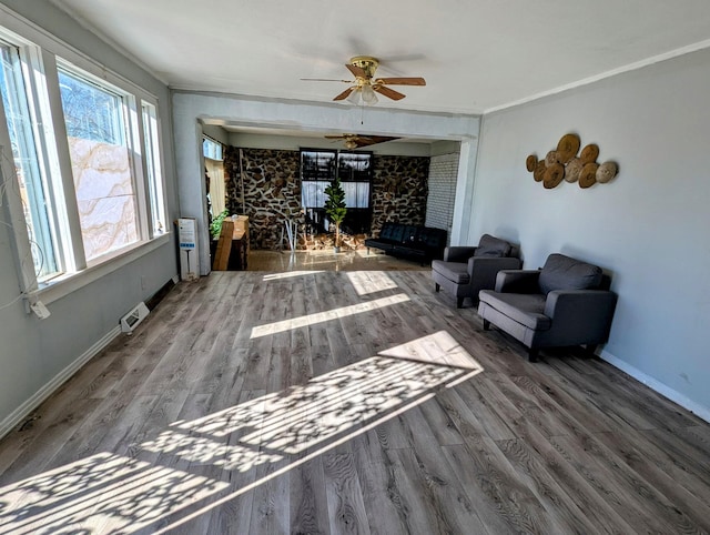 living room with wood-type flooring and ceiling fan