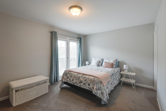 carpeted bedroom featuring baseboards