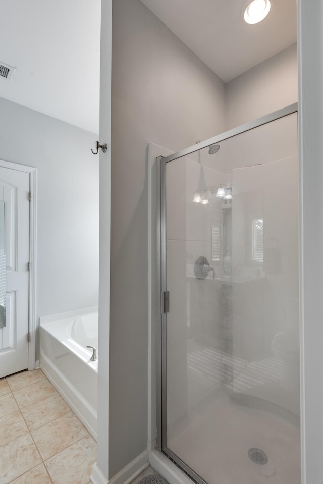 bathroom with visible vents, a garden tub, a shower stall, and tile patterned floors