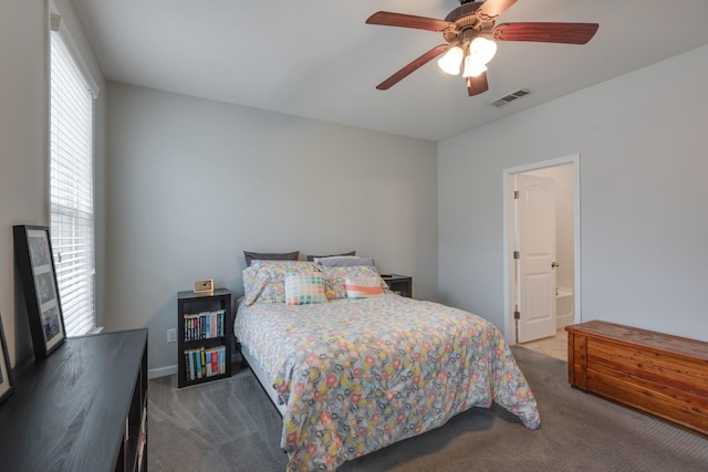 bedroom with a ceiling fan, visible vents, carpet flooring, and ensuite bathroom