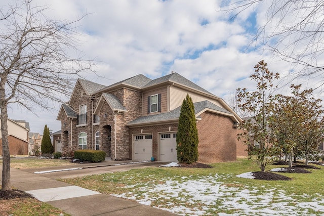 view of front of property featuring a garage and a front lawn