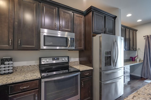 kitchen featuring dark wood-style flooring, stainless steel appliances, recessed lighting, dark brown cabinetry, and light stone countertops