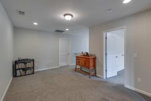 carpeted empty room with recessed lighting, visible vents, and baseboards