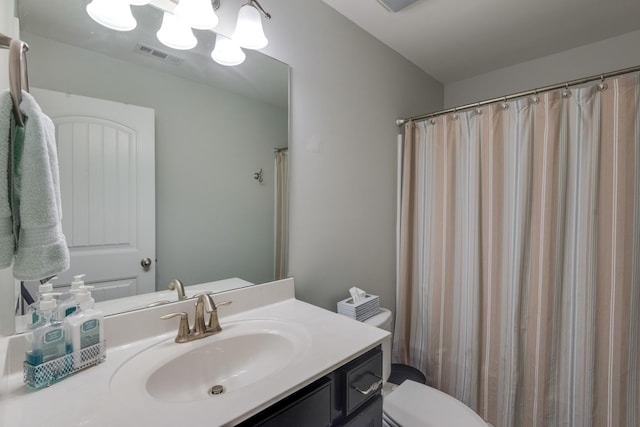 bathroom featuring toilet, visible vents, a chandelier, and vanity