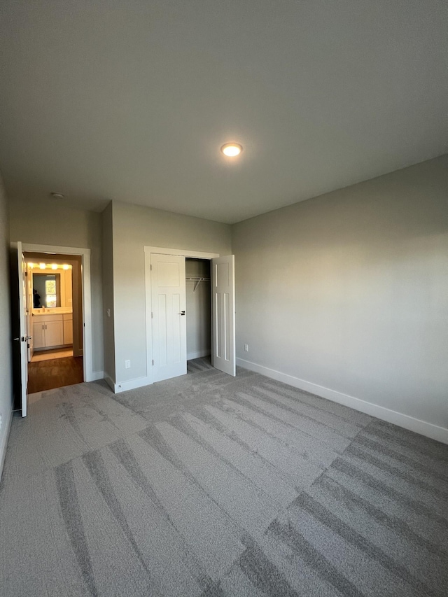 unfurnished bedroom with carpet and a closet