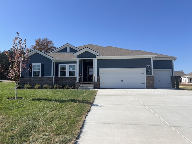 view of front of home featuring a garage and a front lawn