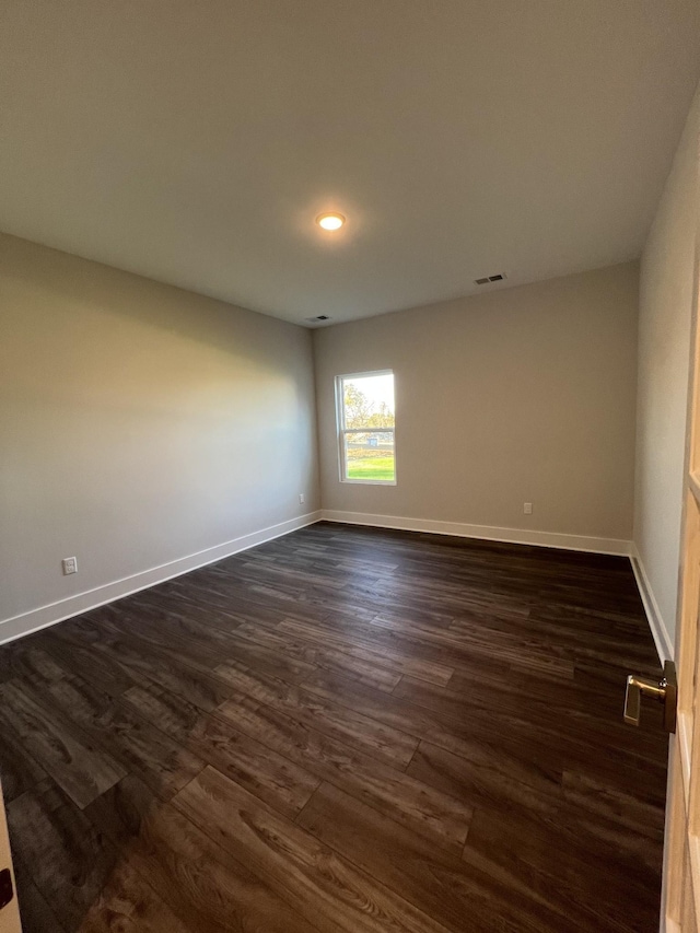 empty room with dark wood-type flooring