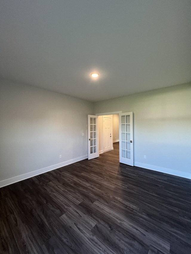 unfurnished room with dark wood-type flooring and french doors