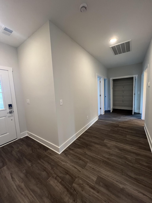 corridor with dark wood-type flooring