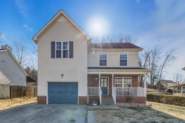 view of property with a garage and covered porch