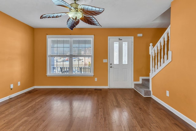 foyer entrance with hardwood / wood-style flooring, ceiling fan, and a wealth of natural light