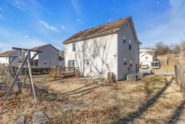 back of property with cooling unit and a deck