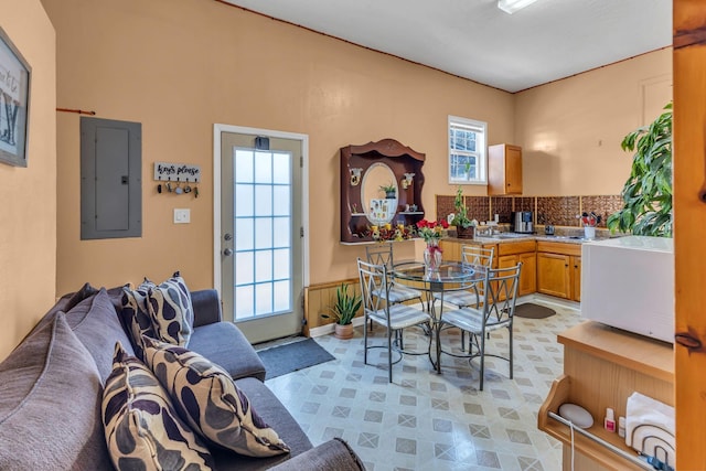 interior space featuring electric panel, decorative backsplash, and a wealth of natural light