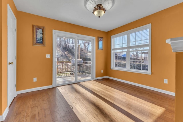 unfurnished room with hardwood / wood-style flooring