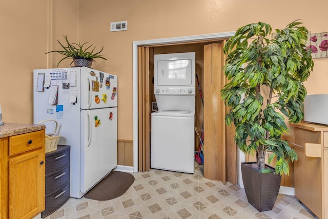 laundry area featuring stacked washer and dryer