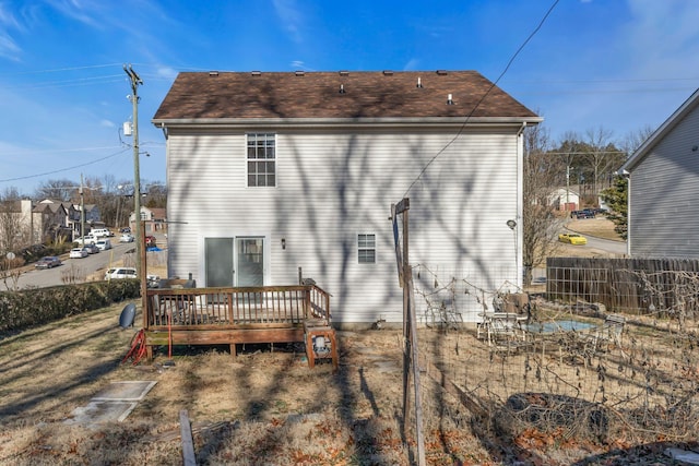 back of house with a wooden deck