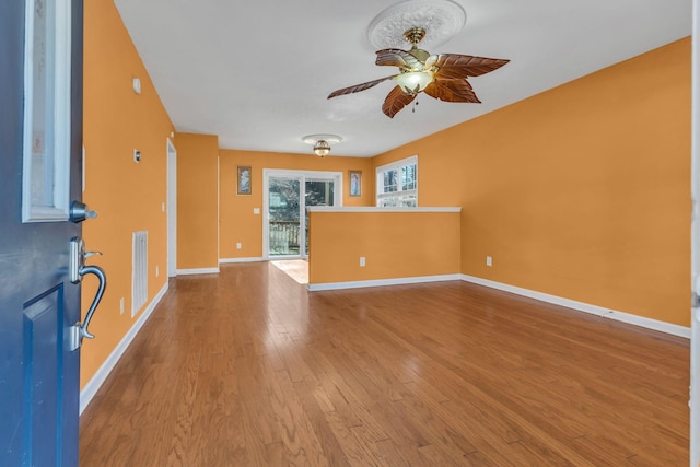 unfurnished living room featuring ceiling fan and light wood-type flooring