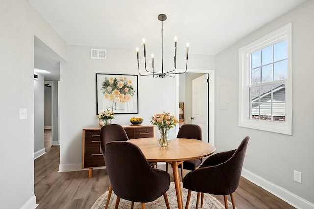 dining room featuring a notable chandelier and hardwood / wood-style flooring